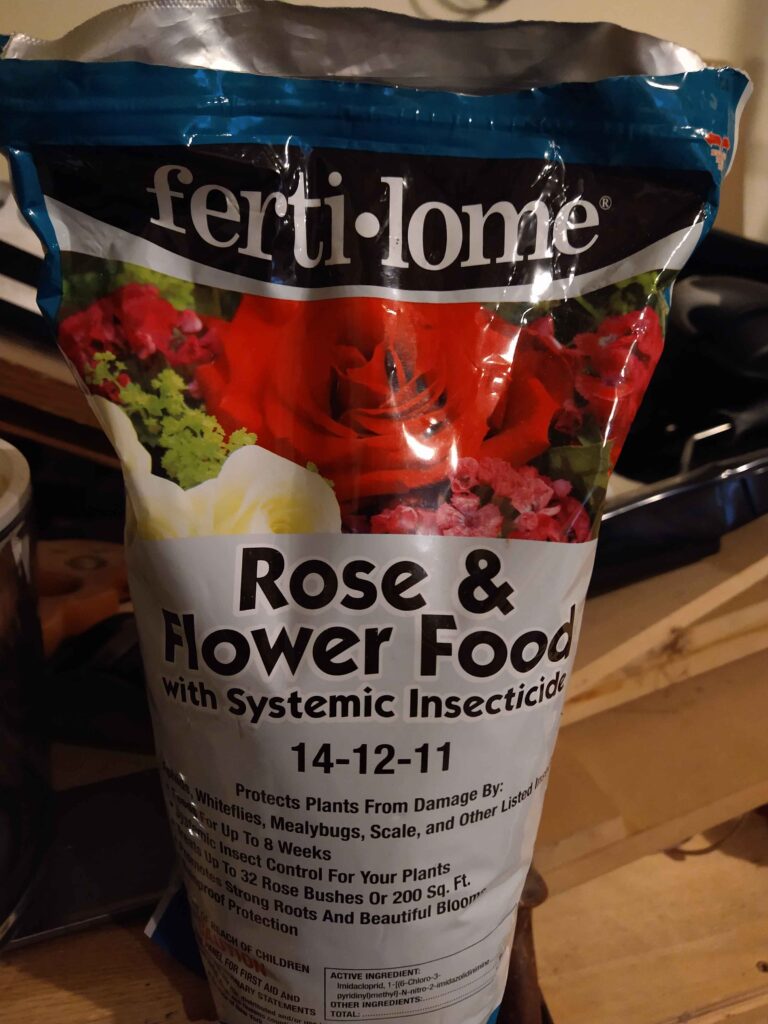 An opened bag of fertilome rose and flower food with systemic insecticide