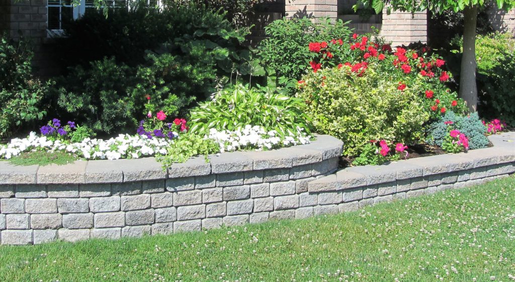 Landscape design with multiple levels and a stone retaining wall