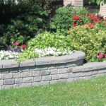 Landscape design with multiple levels and a stone retaining wall