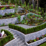 A stone retaining wall in a landscaped garden